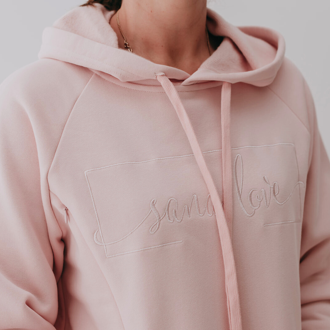 Dusty pink hoodie with embroidery logo and hidden zips.